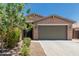 Charming single-story home featuring a well-maintained yard and a neutral stucco finish at 8735 N 185Th Ave, Waddell, AZ 85355
