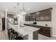 Modern kitchen with granite countertops, stainless steel appliances, and a large island with seating at 8735 N 185Th Ave, Waddell, AZ 85355