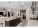 Spacious kitchen with large island, granite countertops, pendant lighting, and stainless steel appliances at 8735 N 185Th Ave, Waddell, AZ 85355