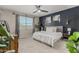 Tranquil main bedroom with a large window, ceiling fan, decorative wall art, and cozy furnishings at 8735 N 185Th Ave, Waddell, AZ 85355