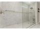Modern bathroom featuring a glass-enclosed shower with neutral tile and dual shower heads at 8735 N 185Th Ave, Waddell, AZ 85355