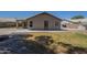 The backyard features a grassy area surrounded by small rocks and desert landscaping at 890 N Bogle Ct, Chandler, AZ 85225