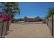 Backyard with large, graveled area, flowers, and well kept block fence at 890 N Bogle Ct, Chandler, AZ 85225