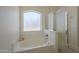 A bathtub offers a frosted window to allow light and privacy at 890 N Bogle Ct, Chandler, AZ 85225