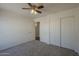 A neutral bedroom has a ceiling fan and a closet with sliding doors at 890 N Bogle Ct, Chandler, AZ 85225