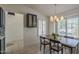 Inviting dining area featuring modern lighting, natural light, a rustic table, and stylish navy cabinets at 890 N Bogle Ct, Chandler, AZ 85225