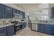 Stylish kitchen featuring navy cabinets, quartz countertops, stainless appliances, and decorative tile backsplash design at 890 N Bogle Ct, Chandler, AZ 85225