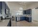 Modern kitchen boasts navy cabinets, stainless appliances, and a decorative tile backsplash, creating a stylish cooking space at 890 N Bogle Ct, Chandler, AZ 85225