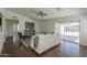 Spacious living room with wood floors, neutral decor, patio access, and ceiling fan at 890 N Bogle Ct, Chandler, AZ 85225