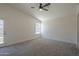 Bright main bedroom shows carpet, vaulted ceiling, ceiling fan, and door to the outside at 890 N Bogle Ct, Chandler, AZ 85225