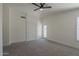 Bright main bedroom shows carpet, vaulted ceiling, ceiling fan, and door to the outside at 890 N Bogle Ct, Chandler, AZ 85225