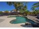 Inviting backyard pool surrounded by palm trees, rocks, and desert landscaping at 890 N Bogle Ct, Chandler, AZ 85225