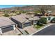 An aerial view of a home featuring a brick driveway, tile roof, well-manicured lawn, and desert landscaping at 9029 S 15Th St, Phoenix, AZ 85042