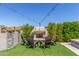 Inviting backyard with a cozy fireplace and chairs, perfect for outdoor gatherings at 9029 S 15Th St, Phoenix, AZ 85042