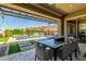 Relaxing backyard featuring a covered patio, a swimming pool, and desert landscaping at 9029 S 15Th St, Phoenix, AZ 85042