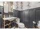 Stylish powder room with elegant black wall trim, patterned wallpaper and gold hardware at 9029 S 15Th St, Phoenix, AZ 85042