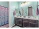 Stylish bathroom with a double sink vanity, decorative mirrors, and a shower/tub combination at 9029 S 15Th St, Phoenix, AZ 85042