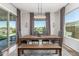 Cozy dining room features an elegant light fixture, table, chairs and a bench at 9029 S 15Th St, Phoenix, AZ 85042