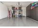 Spacious garage with epoxy flooring, storage cabinets, and overhead racks at 9029 S 15Th St, Phoenix, AZ 85042