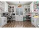 Bright home office featuring dual workstations, built-in cabinets, and wood-look flooring at 9029 S 15Th St, Phoenix, AZ 85042