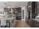 Modern kitchen with dark wood cabinets, stainless steel appliances, and a large center island with seating at 9029 S 15Th St, Phoenix, AZ 85042