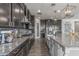 Spacious kitchen features granite counters, wood floors, stainless appliances and designer lighting at 9029 S 15Th St, Phoenix, AZ 85042