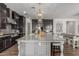 Beautiful kitchen featuring dark cabinets, a large center island with seating, and stainless steel appliances at 9029 S 15Th St, Phoenix, AZ 85042