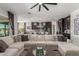 Spacious living room featuring a large sectional sofa, modern decor, and an open floorplan to the kitchen at 9029 S 15Th St, Phoenix, AZ 85042