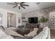 Comfortable living room featuring a brick accent wall, neutral sectional, and ample natural light at 9029 S 15Th St, Phoenix, AZ 85042