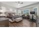 Open main bedroom with wood floors, neutral walls, and a large bed at 9029 S 15Th St, Phoenix, AZ 85042