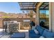 Inviting outdoor kitchen featuring a built-in grill and a comfortable seating area at 9029 S 15Th St, Phoenix, AZ 85042