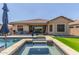 Luxurious backyard pool and spa with a covered patio area for relaxation at 9029 S 15Th St, Phoenix, AZ 85042