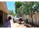 Charming backyard with dining set, grill, and mature landscaping creating a private oasis at 9235 N 101St St, Scottsdale, AZ 85258