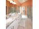 Spacious bathroom featuring double sinks, granite countertops, and glass shower at 9235 N 101St St, Scottsdale, AZ 85258