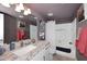Bathroom featuring a white granite counter, framed mirror and shower with tub at 9235 N 101St St, Scottsdale, AZ 85258