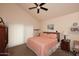 Comfortable bedroom with a ceiling fan, bedside table, and a double bed at 9235 N 101St St, Scottsdale, AZ 85258