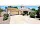Home exterior boasts a tile roof, two-car garage, and desert landscaping at 9235 N 101St St, Scottsdale, AZ 85258