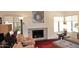 Living room fireplace with brick surround, stylish decor, and ample natural light at 9235 N 101St St, Scottsdale, AZ 85258