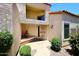 Charming front entrance with decorative accents, covered porch, and lush landscaping at 9235 N 101St St, Scottsdale, AZ 85258