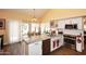 Well-lit kitchen featuring granite counters, stainless steel appliances, and wood-like floors at 9235 N 101St St, Scottsdale, AZ 85258