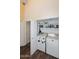 Convenient laundry room with a washer and dryer and some storage shelves at 9235 N 101St St, Scottsdale, AZ 85258