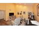 Spacious living room featuring a piano, large TV, and comfortable seating at 9235 N 101St St, Scottsdale, AZ 85258