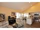 Open-concept living space with hardwood floors, a breakfast bar, and vaulted ceilings at 9235 N 101St St, Scottsdale, AZ 85258