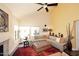 Spacious living room boasts high ceilings, ceiling fan, and large windows at 9235 N 101St St, Scottsdale, AZ 85258