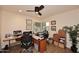 Functional office space featuring a desk, large windows and ceiling fan at 9235 N 101St St, Scottsdale, AZ 85258