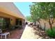 Outdoor patio featuring tile flooring, dining set, and lush landscaping, ideal for entertaining at 9235 N 101St St, Scottsdale, AZ 85258