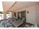 Cozy covered patio with outdoor seating and a table with a grill at 9235 N 101St St, Scottsdale, AZ 85258
