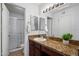 Bathroom features a granite countertop, dark wood cabinets, and a shower with glass doors at 10115 E Mountain View Rd # 2061, Scottsdale, AZ 85258