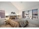 Bright bedroom with large window, neutral decor, and comfortable queen-sized bed at 10115 E Mountain View Rd # 2061, Scottsdale, AZ 85258