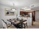 Dining area with modern table setting, stylish lighting, and open view to the kitchen with stainless steel appliances at 10115 E Mountain View Rd # 2061, Scottsdale, AZ 85258